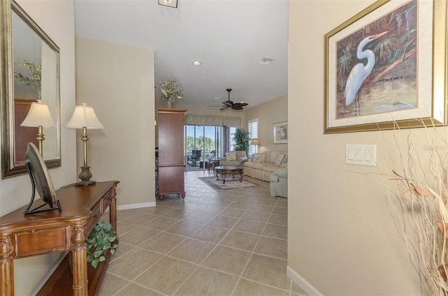 corridor featuring recessed lighting, light tile patterned floors, baseboards, and visible vents