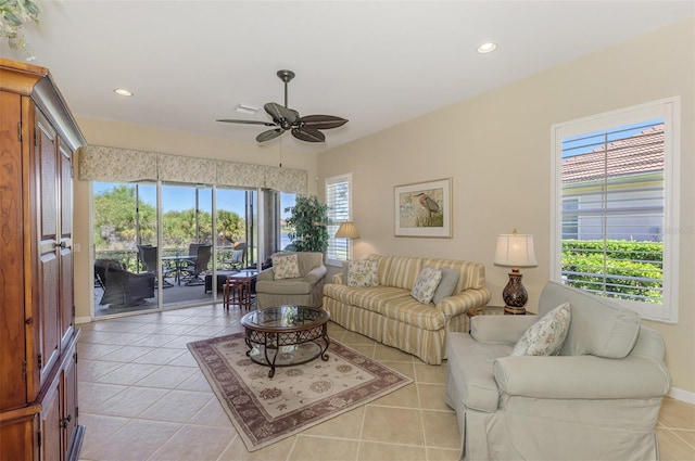 living room with light tile patterned floors, recessed lighting, baseboards, and ceiling fan