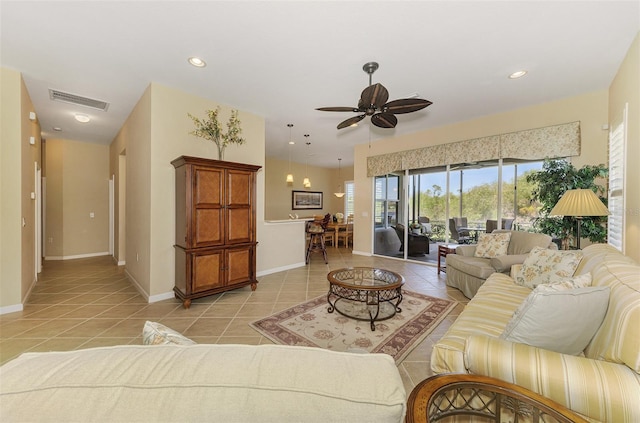 living room featuring light tile patterned floors, visible vents, baseboards, and recessed lighting