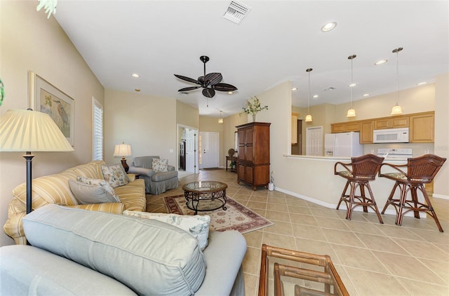 living area with light tile patterned floors, a ceiling fan, visible vents, baseboards, and recessed lighting