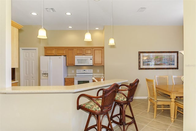 kitchen with light tile patterned floors, visible vents, white appliances, and light countertops