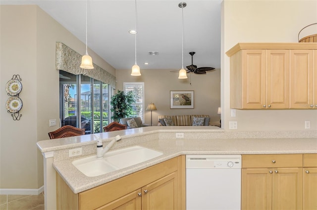 kitchen featuring visible vents, light brown cabinets, a sink, light countertops, and dishwasher