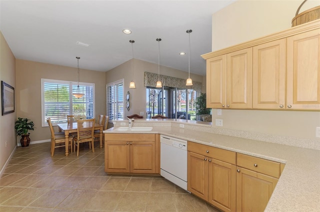 kitchen with decorative light fixtures, dishwasher, light countertops, a peninsula, and a sink