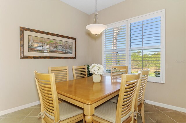 dining room with tile patterned flooring and baseboards