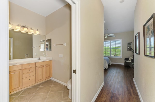 full bathroom with tile patterned floors, ensuite bathroom, baseboards, and double vanity