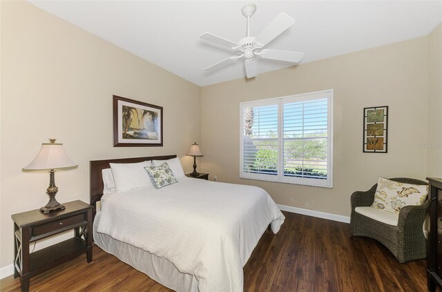 bedroom with ceiling fan, baseboards, and wood finished floors