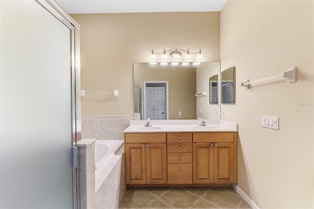 bathroom with tile patterned flooring, double vanity, a bath, and a sink