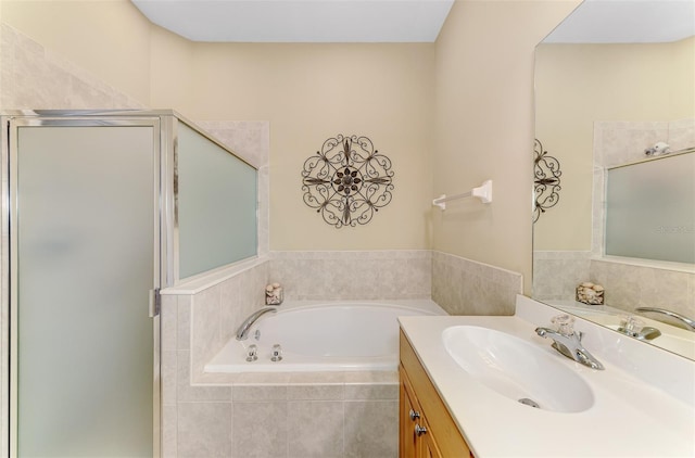 bathroom featuring a stall shower, a bath, and vanity