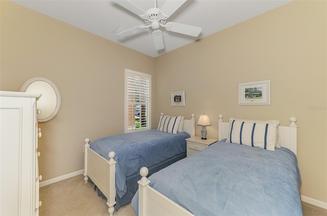 bedroom with light colored carpet, baseboards, and ceiling fan