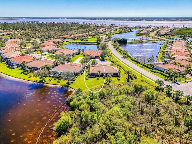 birds eye view of property featuring a residential view and a water view