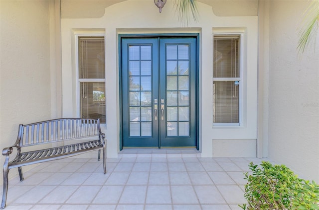 doorway to property featuring french doors and stucco siding