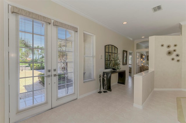 entryway with visible vents, baseboards, ornamental molding, light tile patterned floors, and recessed lighting