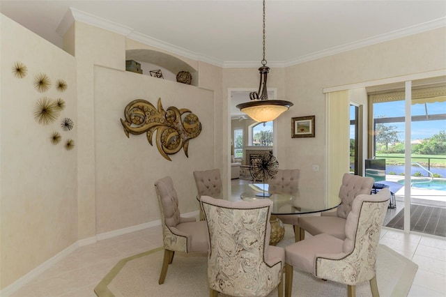 dining space with a wealth of natural light, light tile patterned floors, and ornamental molding