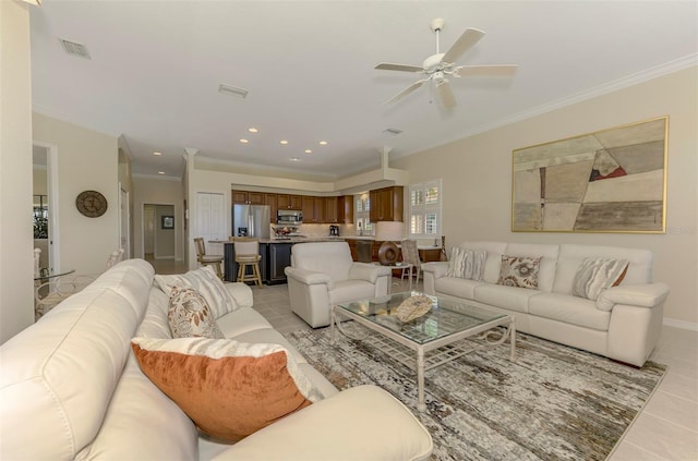 living room featuring recessed lighting, light tile patterned flooring, and ornamental molding