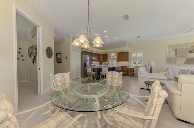 dining area featuring light tile patterned floors, visible vents, ornamental molding, and a chandelier