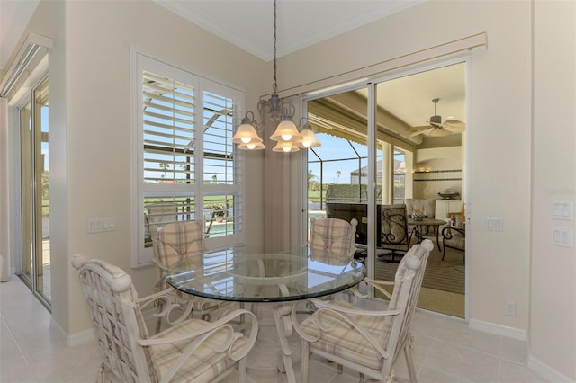 tiled dining area featuring a notable chandelier, baseboards, and ornamental molding