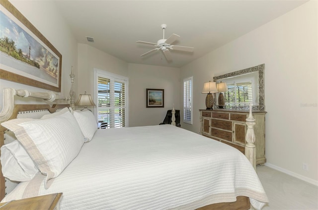 carpeted bedroom with baseboards, visible vents, and ceiling fan