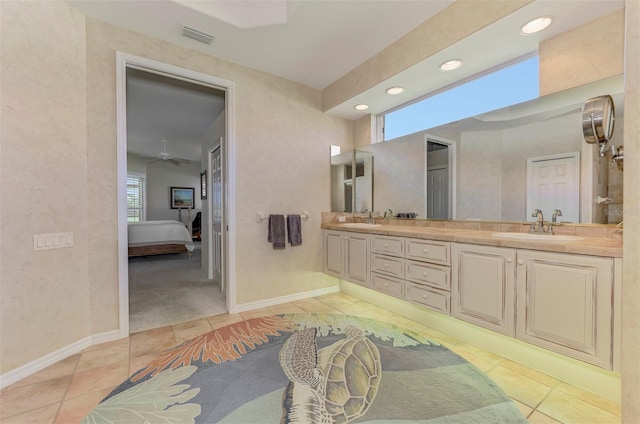 full bathroom with tile patterned flooring, visible vents, double vanity, and a sink