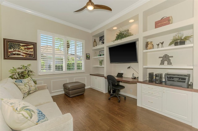 home office with built in features, dark wood finished floors, built in desk, crown molding, and ceiling fan