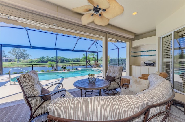 interior space featuring ceiling fan, an outdoor pool, a water view, and a lanai