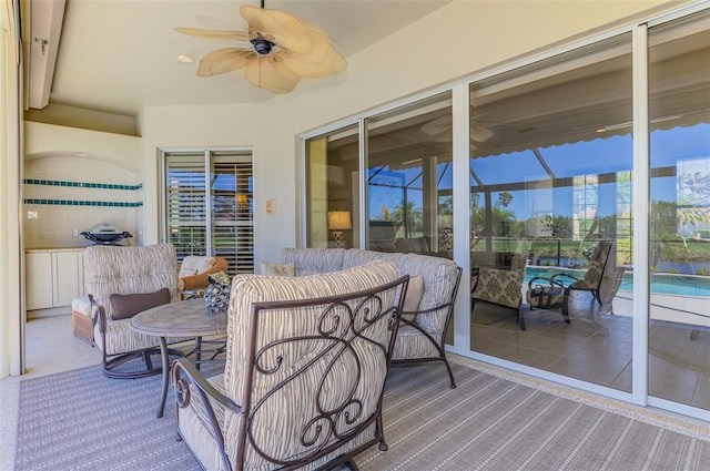 sunroom featuring a wealth of natural light and a ceiling fan