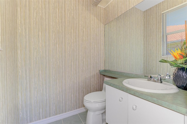 half bath featuring tile patterned floors, toilet, and vanity