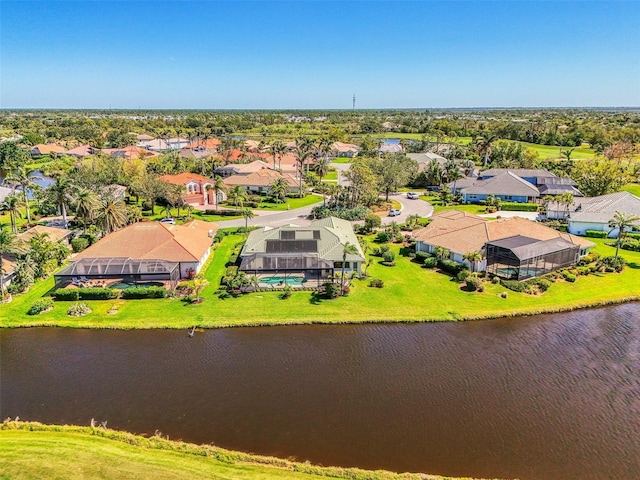 drone / aerial view featuring a residential view and a water view