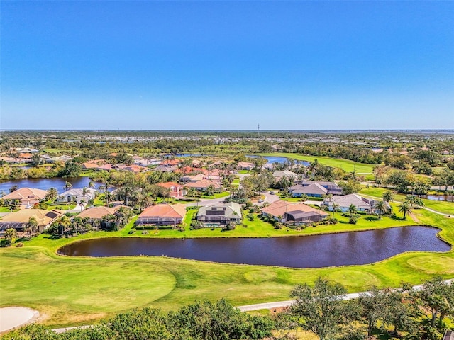 birds eye view of property with a water view and golf course view