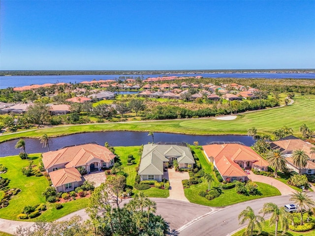 aerial view with view of golf course, a residential view, and a water view