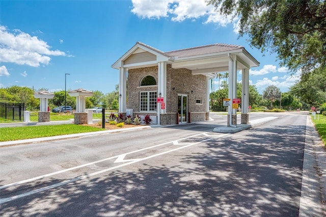 exterior space featuring traffic signs and curbs