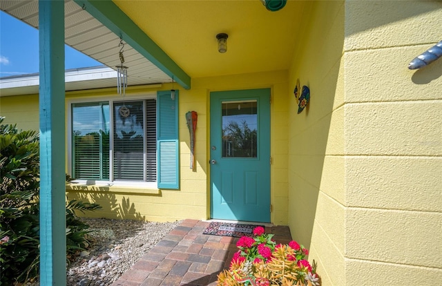 property entrance featuring concrete block siding