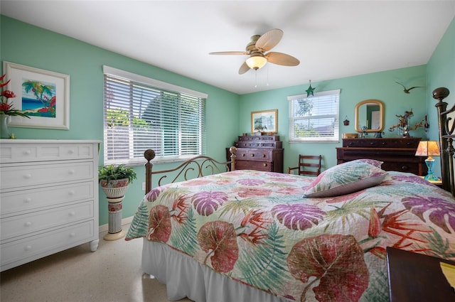 bedroom with a ceiling fan and baseboards