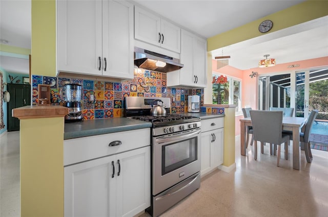 kitchen featuring under cabinet range hood, white cabinetry, backsplash, dark countertops, and gas range