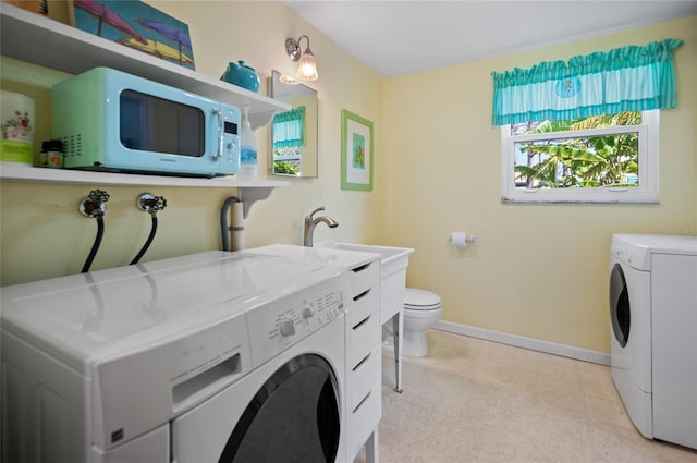 laundry area featuring laundry area, independent washer and dryer, and baseboards