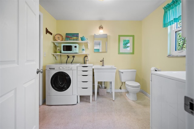 laundry area featuring laundry area, washer / clothes dryer, and baseboards