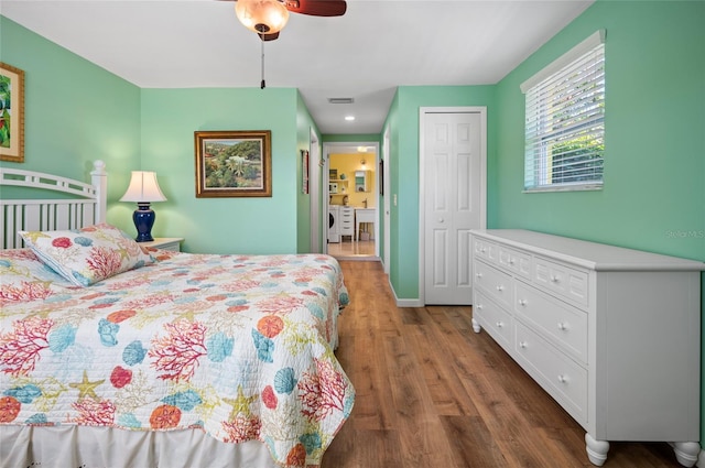 bedroom featuring baseboards, visible vents, a ceiling fan, wood finished floors, and a closet