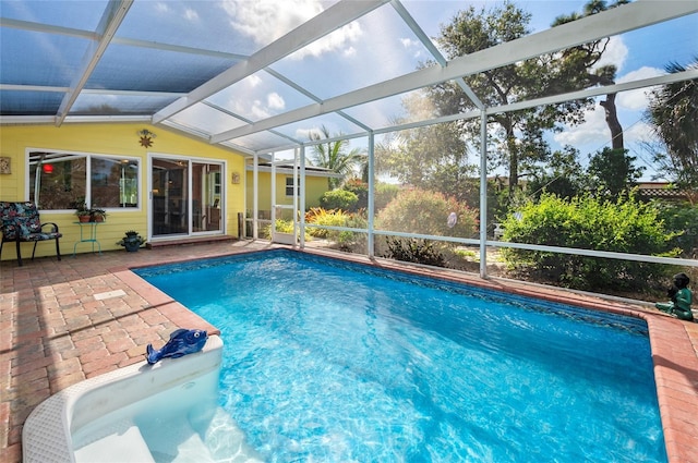 pool with glass enclosure and a patio