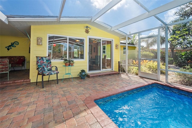 view of swimming pool featuring a lanai and a patio area