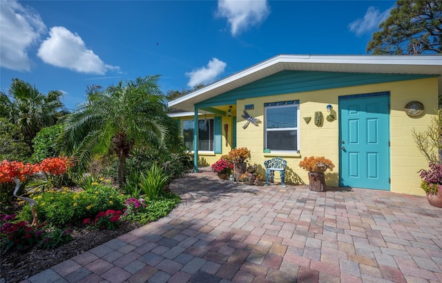 view of exterior entry with concrete block siding