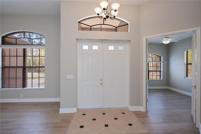 entryway featuring plenty of natural light, baseboards, and light wood-style flooring