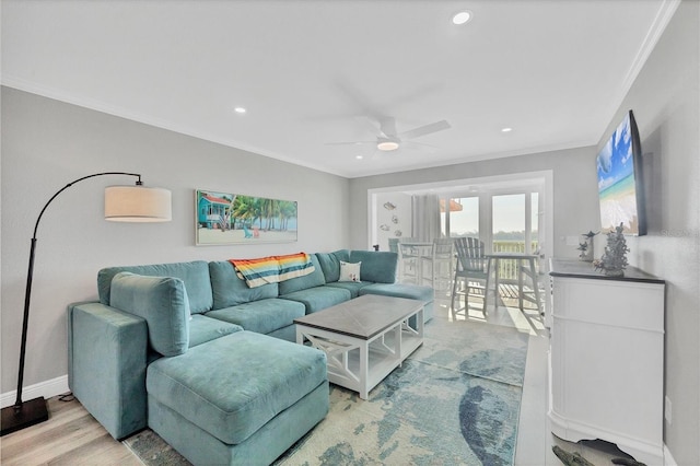 living room with ornamental molding, recessed lighting, wood finished floors, and baseboards