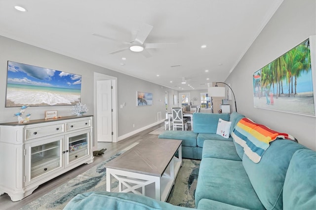 living area with ornamental molding, recessed lighting, ceiling fan, and wood finished floors