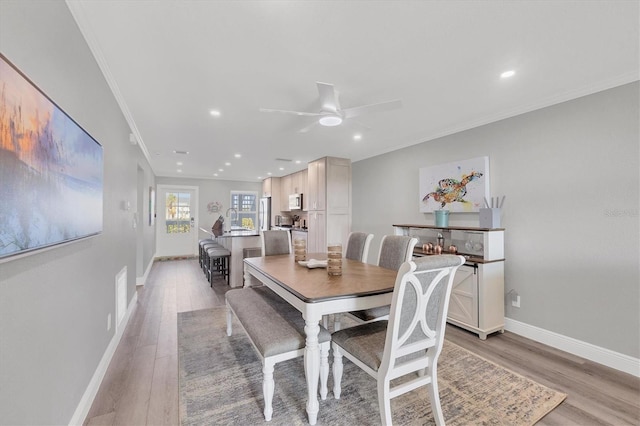 dining area featuring recessed lighting, ornamental molding, light wood-style floors, ceiling fan, and baseboards