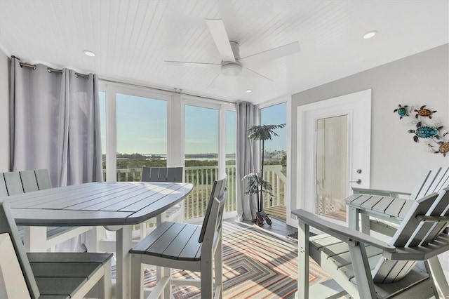 sunroom with wood ceiling and a ceiling fan