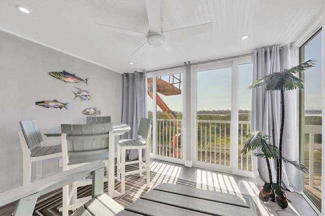 sunroom featuring ceiling fan