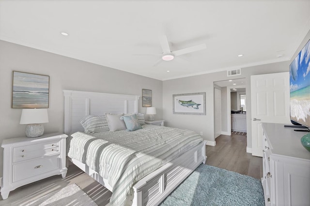 bedroom featuring dark wood-style floors, visible vents, ornamental molding, a ceiling fan, and baseboards