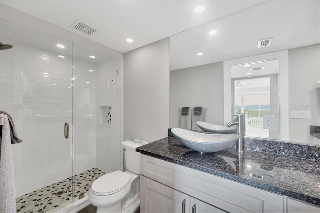 full bath featuring a stall shower, visible vents, vanity, and toilet