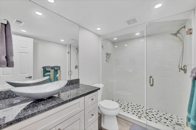 full bath featuring vanity, a shower stall, visible vents, and recessed lighting