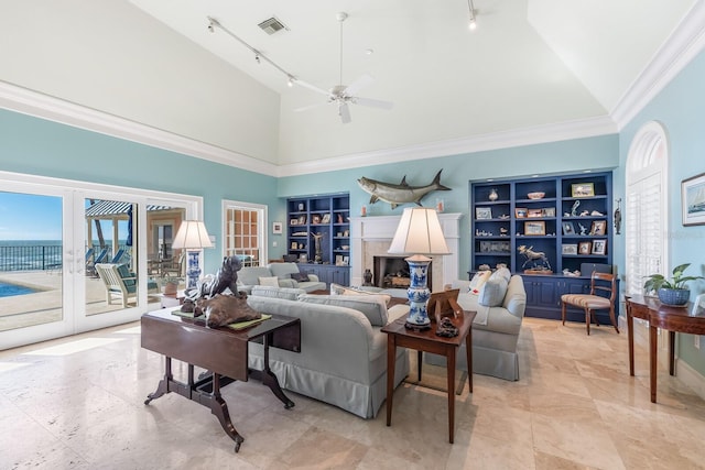 living room with built in shelves, french doors, visible vents, and track lighting