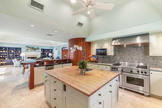 kitchen featuring black microwave, extractor fan, visible vents, and double oven range